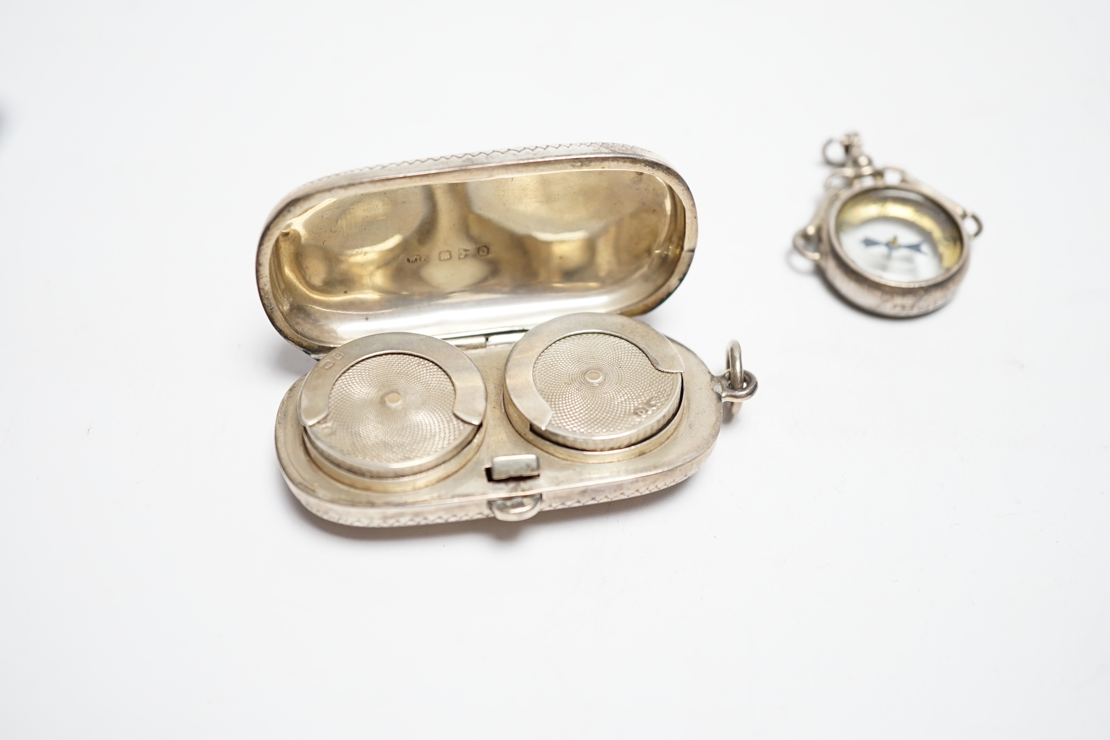 A late Victorian silver twin sovereign case, Chester, 1899 and a George V silver mounted compass fob.